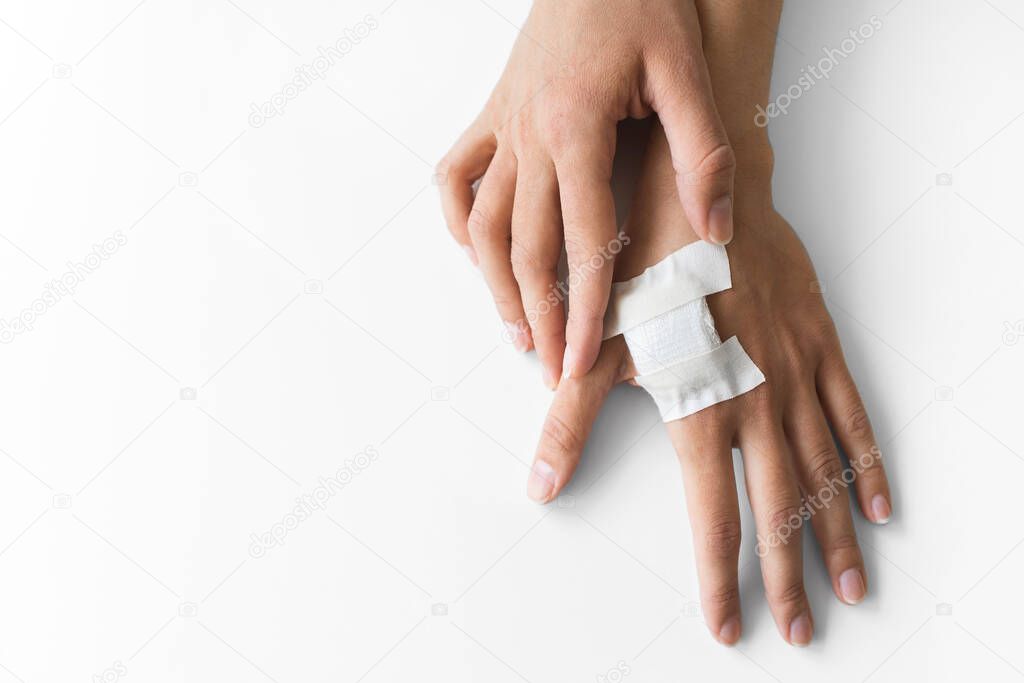 Woman hand with plaster bandage after mandatory medical chipization in Sweden. Implantation of microchip in hand. Health control of citizens.