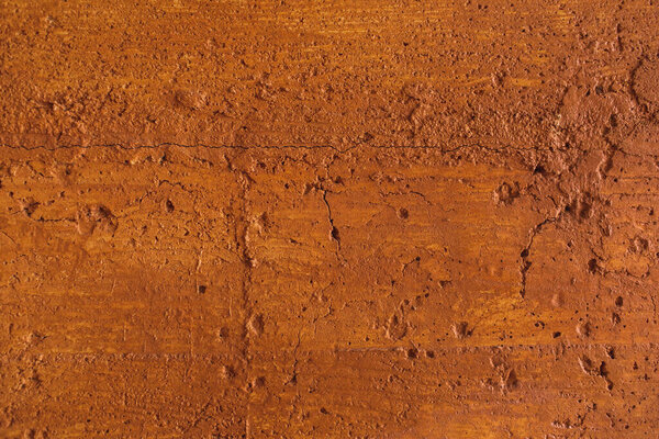 Traditional moroccan terracotta colored background. Orange or ocher clay wall texture. Painted shabby concrete.