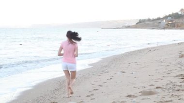 Kız sabah denize sıfır plaj boyunca çalışır