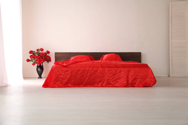 the Interior of the white room with a bed with red
