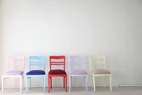 White room with colorful chairs blue yellow red blue purple — Stock Photo, Image