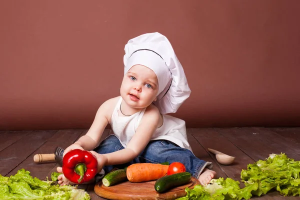 Little boy chef prepares food salad, tomato, carrot, cucumber — Stock Photo, Image