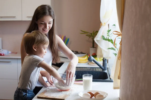 Mutter und Sohn bereiten Kuchen mit Mehl zu — Stockfoto