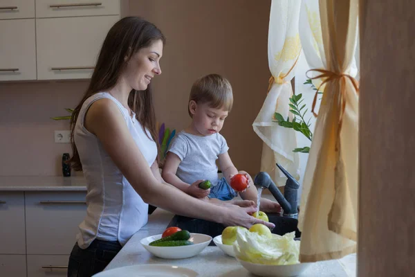 Kitchen mom son wash fruits and vegetables — Stock Photo, Image