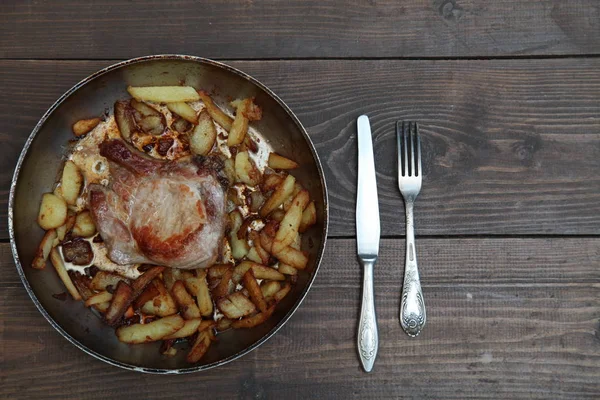bir tablo üzerinde et ve patates tava ile akşam yemeği kızarmış