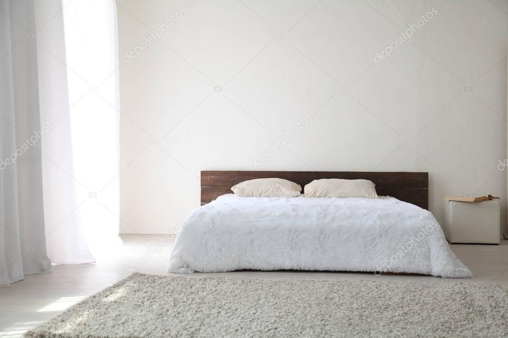 White bedroom bright interiors with bed