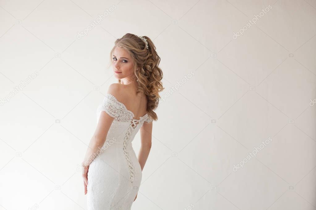 beautiful bride posing wedding hairstyle and dress