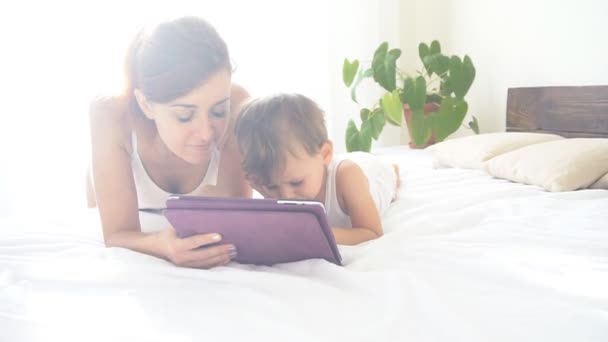 Mor och unga son använder tabletten för onlinespel — Stockvideo