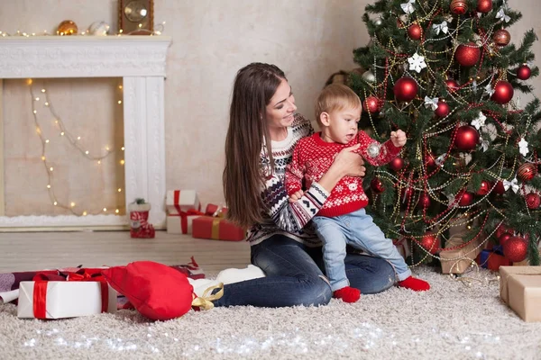 Moeder met zoon boom op new years giften van Kerstmis verfraaien — Stockfoto