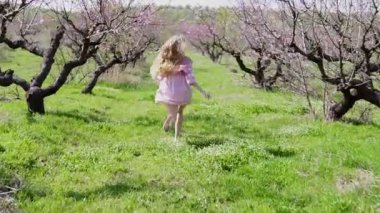 çiçekli ağaçlar bahçede pembe elbiseli sarışın çalışır