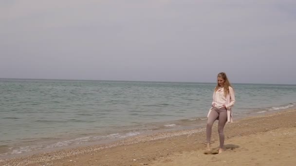 Одна блондинка на пляжі біля моря — стокове відео