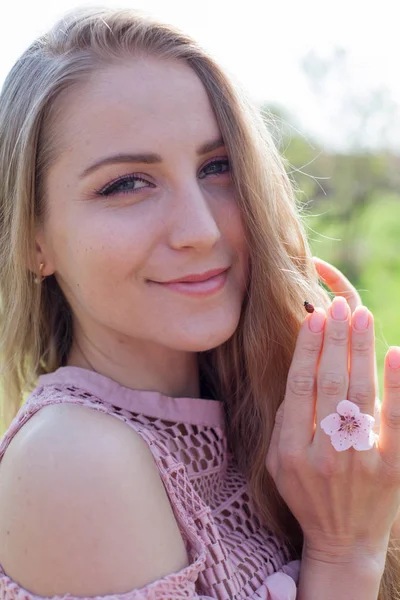 blonde girl on hand a ladybug