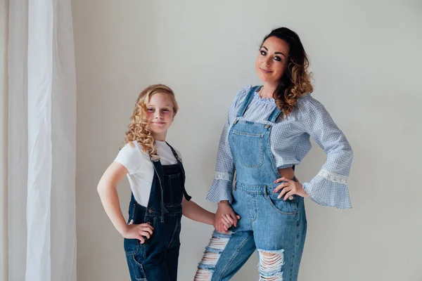 Portrait of a beautiful fashionable mom and daughters family love