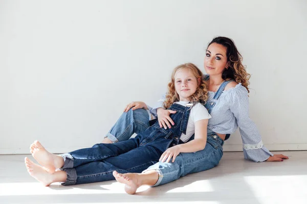 Portrait of a beautiful fashionable mom and daughters family love