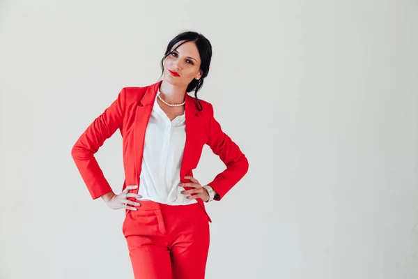 Portrait of a business woman brunette in a red business suit in the office — Stock Photo, Image
