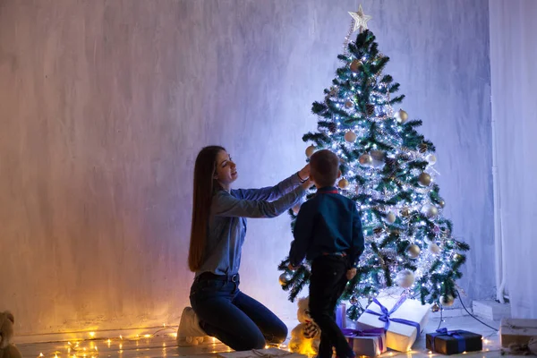 Mom and son at the Christmas tree with gifts of new year decor winter — Stock Photo, Image