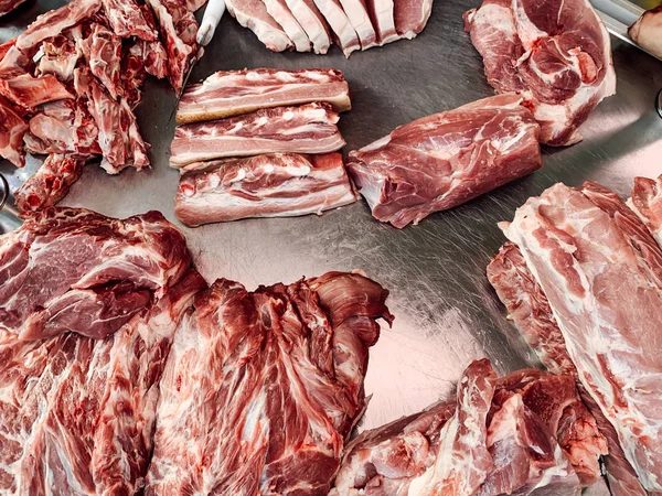 Lots of fresh meat for cooking on the table as a background — Stock Photo, Image