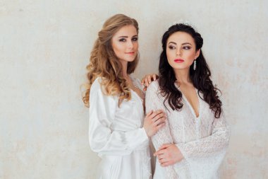 Beyaz iç çamaşırlı iki kız sarışın ve esmer.