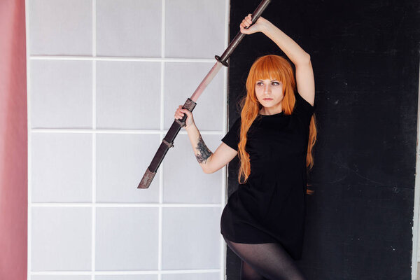 beautiful woman anime cosplayer with red hair with Japanese sword