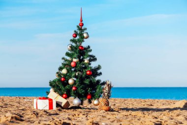 Christmas tree on tropical beach holidays winter clipart
