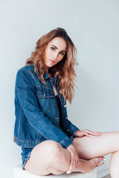 Portrait of a beautiful fashionable woman in lingerie and denim shorts — Stock Photo, Image
