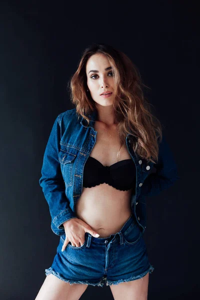 Portrait of a beautiful fashionable woman in lingerie and denim shorts — ストック写真