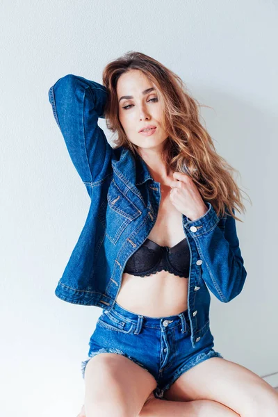 Portrait of a beautiful fashionable woman in jeans and black lingerie style — 스톡 사진