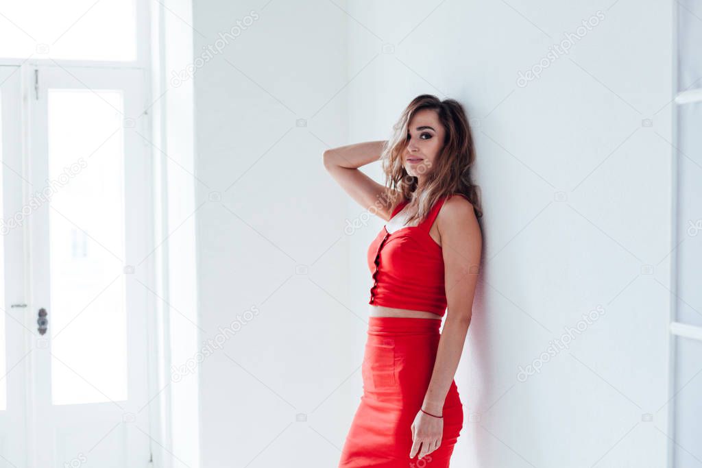 Portrait of a beautiful fashionable woman in red dress style clothing