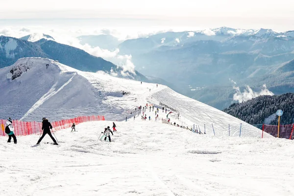 Skiers and snowboarders ride on mountain slopes of the ski resort winter vacation travel — Stock Photo, Image