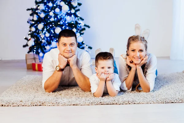 Mom dad and son decorate Christmas tree gifts new year tree winter holiday Garland — Stock Photo, Image