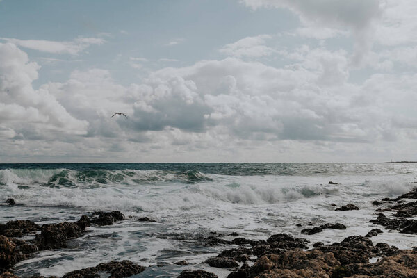 the stone Beach ocean wave sky with clouds