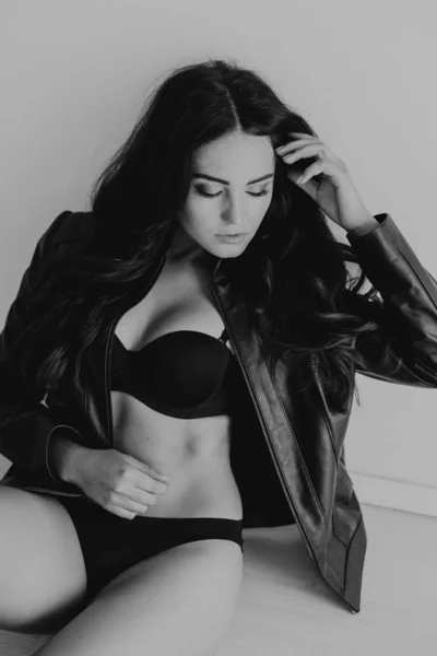 Brunette girl in leather jacket and black lingerie — Stock Photo, Image