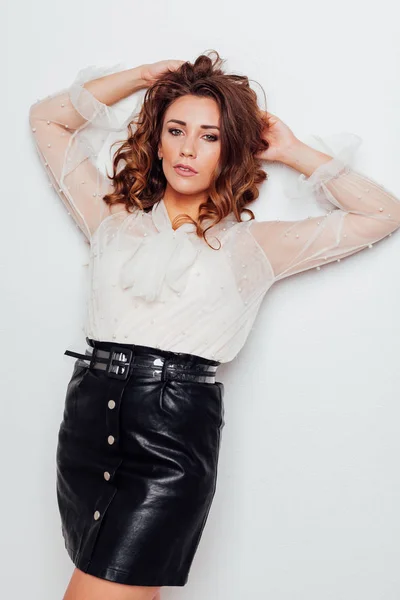 Portrait of a beautiful fashionable woman with hair curls in a blouse and black skirt — Stock Photo, Image