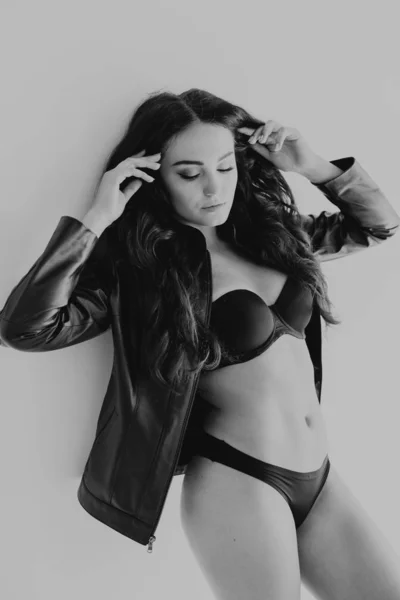 Brunette girl in leather jacket and black lingerie — Stock Photo, Image