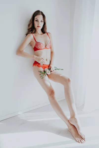 Beautiful woman in red underwear with flowers fashion portrait — Stock Photo, Image