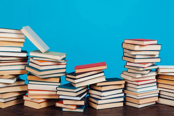 many of educational books for learning preparation for college exams on a blue background