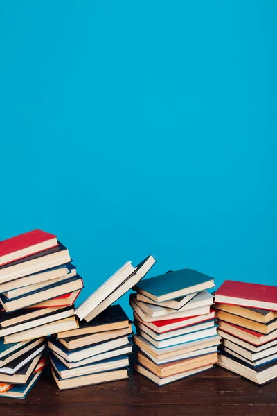 many of educational books for learning preparation for college exams on a blue background
