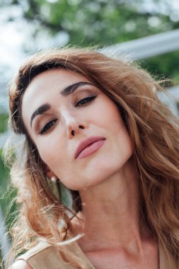 Yürüyüş için bej elbiseli güzel bir kadının portresi.