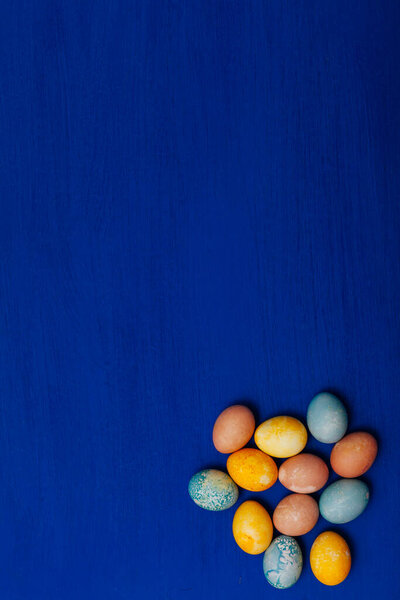 bright Easter holiday egg cake blue background