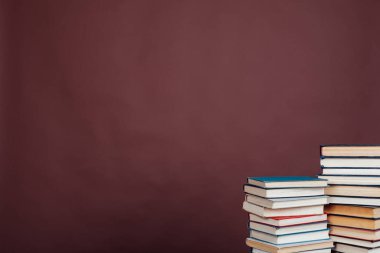 Üniversite kütüphanesinde kahverengi arka planda bir sürü eğitim kitabı var.