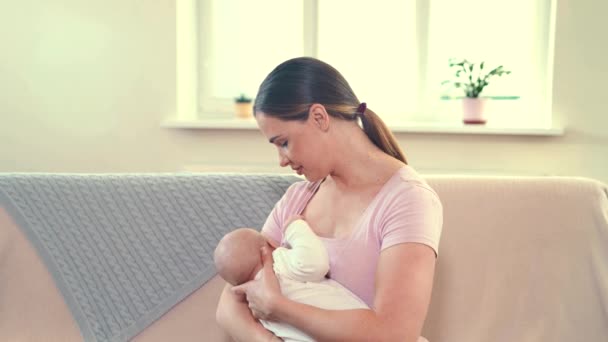 Madre alimentando al bebé en casa. Madre lactante con un niño pequeño — Vídeos de Stock