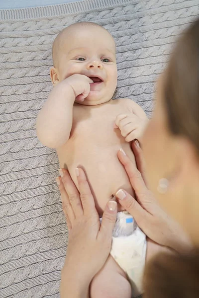 Divertente piccolo bambino che gioca con la mamma su una coperta a maglia — Foto Stock