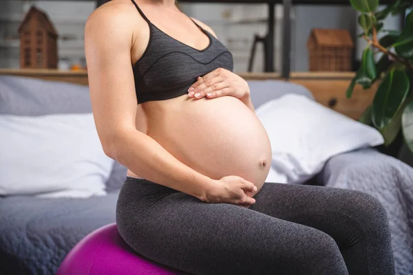 Gravid kvinna gör övningar med gymnastikboll — Stockfoto