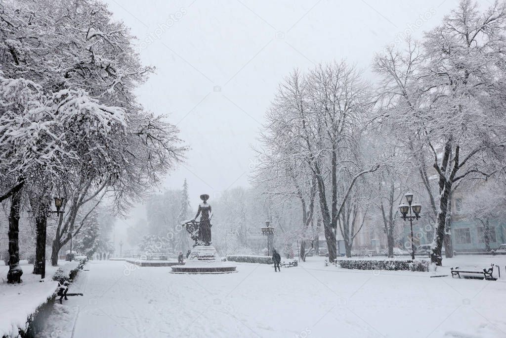 Winter time of silence and rest.  Heavy snow in the streets and parks of Ternopil. Color swing for two. Seasons in Ukraine. Swings and sleds for children and adults. Snowy winter landscapes. Winter faity tale for children and adults.
