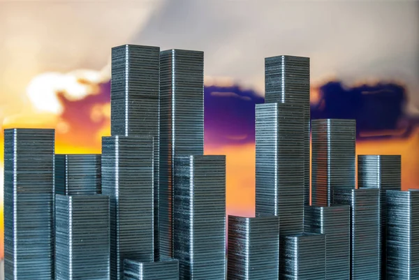 Staples arranged to form city skyline on a sunset background — Stock Photo, Image