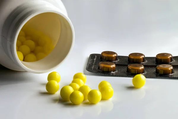 Prescription pill bottle spilling pills on to surface isolated o