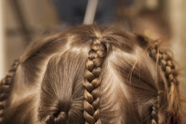 Close up of braid hair of little girl with colorful rubber bands