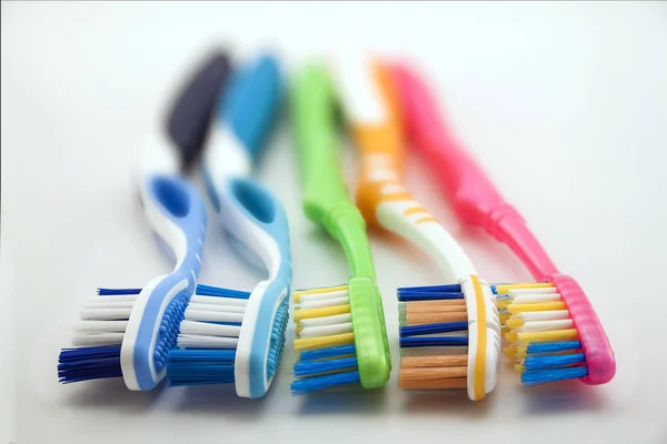 Colorful toothbrushes on white background with copy space. Macro — Stock Photo, Image