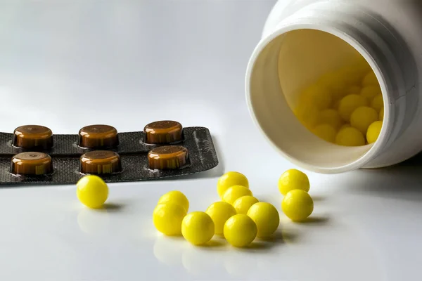 Prescription pill bottle spilling pills on to surface isolated o