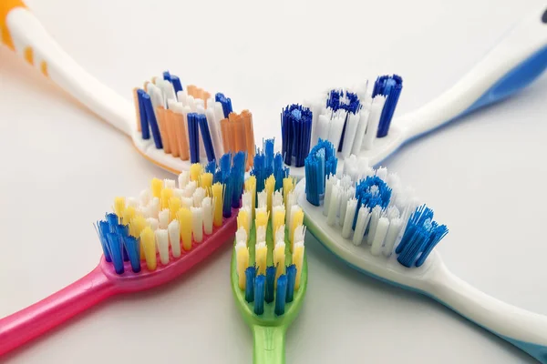 Colorful toothbrushes on white background with copy space. Macro — Stock Photo, Image